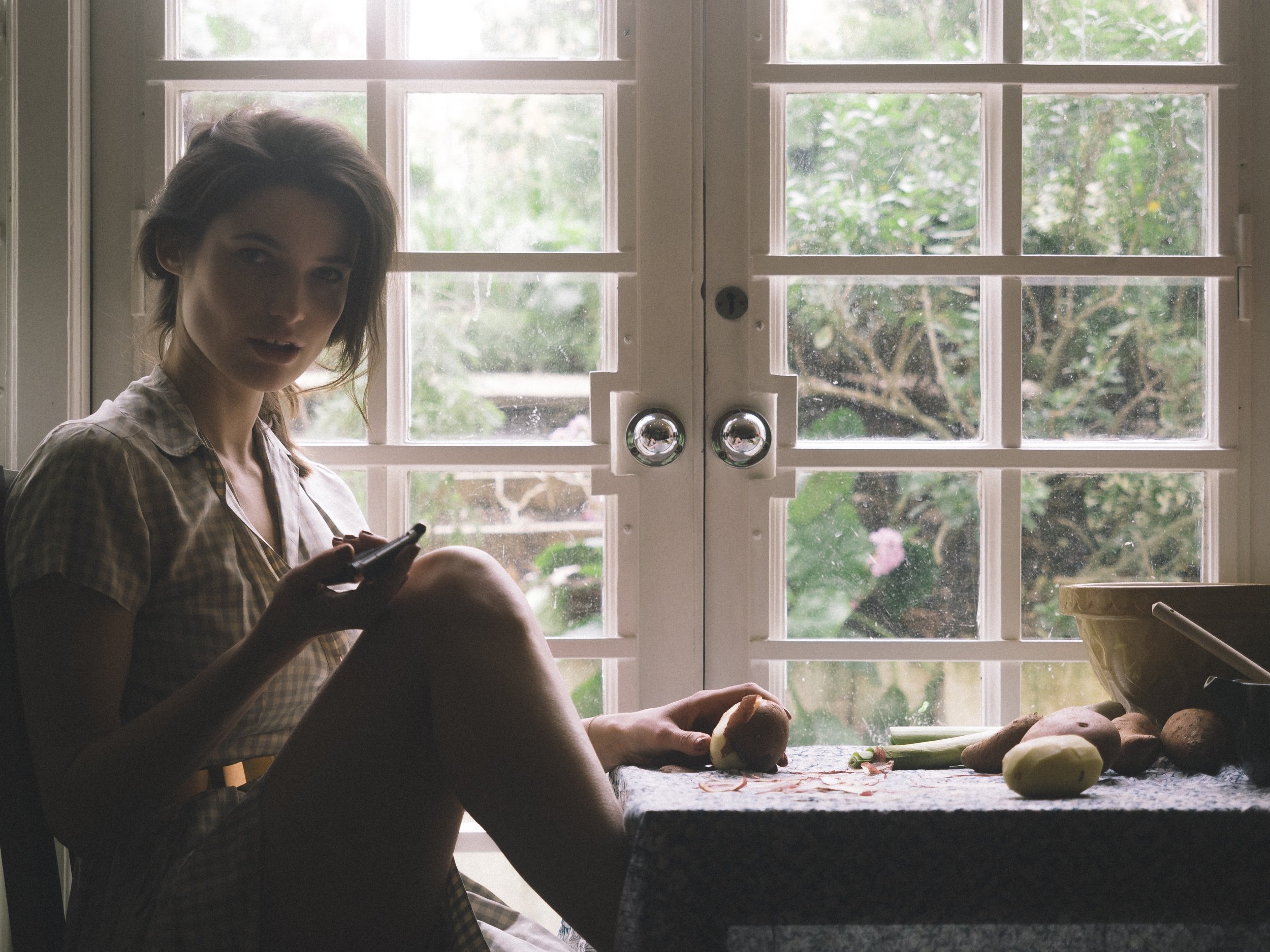 Katie Ball peeling potatoes photoshoot for Harper's Bazaar